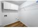 This laundry room provides storage with white cabinets and wire shelving at 1429 Kentmire Court, Locust Grove, GA 30248