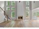 Living room featuring a fireplace, staircase, and lots of windows for ample natural light at 1429 Kentmire Court, Locust Grove, GA 30248