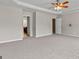 Spacious carpeted bedroom with ceiling fan and views to en suite bathroom and walk in closet at 1429 Kentmire Court, Locust Grove, GA 30248