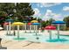 Vibrant splash pad featuring colorful mushroom fountains, offering a playful water experience for children and families at 1429 Kentmire Court, Locust Grove, GA 30248