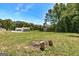 Expansive backyard featuring a fire pit, sheds, and a detached garage at 203 Brannan Rd, Mcdonough, GA 30253