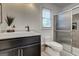 Well-lit bathroom with a glass-enclosed shower, modern vanity, and updated fixtures at 203 Brannan Rd, Mcdonough, GA 30253