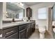Modern bathroom with dark cabinets, a large mirror, and tiled shower offering a sleek and functional design at 203 Brannan Rd, Mcdonough, GA 30253