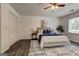 Inviting bedroom with natural light, modern decor, and a ceiling fan; features ample closet space at 203 Brannan Rd, Mcdonough, GA 30253