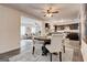 Dining room and kitchen area with open floor plan, modern decor, and light gray laminate floors at 203 Brannan Rd, Mcdonough, GA 30253