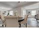 Dining area showcasing modern furnishings, light gray laminate floors, and open floor plan at 203 Brannan Rd, Mcdonough, GA 30253