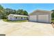 Long driveway leading to the house with a detached garage with a two-car garage door at 203 Brannan Rd, Mcdonough, GA 30253