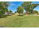 Charming single-story home with well-manicured lawn, mature trees, and a 'For Sale' sign at 203 Brannan Rd, Mcdonough, GA 30253