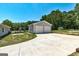 Detached garage with two-car garage door connected to the house by a driveway at 203 Brannan Rd, Mcdonough, GA 30253