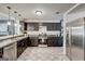 Modern kitchen with stainless steel appliances, dark cabinetry, and stylish tile flooring at 203 Brannan Rd, Mcdonough, GA 30253
