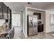 Open kitchen layout with stainless steel refrigerator and access to the laundry room at 203 Brannan Rd, Mcdonough, GA 30253