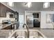 Kitchen view showcasing stainless appliances and open layout to the laundry area at 203 Brannan Rd, Mcdonough, GA 30253