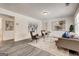 Bright living room featuring modern decor, neutral tones, and light gray laminate floors at 203 Brannan Rd, Mcdonough, GA 30253