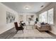 Spacious living room with neutral decor, hardwood floors, and large windows for natural light at 203 Brannan Rd, Mcdonough, GA 30253