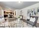 Open floor plan showcases the living room and dining area with modern furnishings and gray flooring at 203 Brannan Rd, Mcdonough, GA 30253