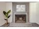 Cozy living room with a decorative fireplace, grey brick, and modern decor creating a welcoming atmosphere at 203 Brannan Rd, Mcdonough, GA 30253