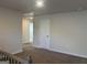 Hallway boasts neutral carpet, walls and a white door to a bedroom or bathroom at 5314 Tolar Rd # 23, South Fulton, GA 30213