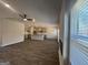 Open-concept kitchen and living area with stainless steel appliances and a cozy fireplace at 5314 Tolar Rd # 23, South Fulton, GA 30213