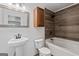 Modern bathroom with wood look shower and pedestal sink offering a spa-like feel at 2265 Venture Dr, Marietta, GA 30062