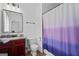 Functional bathroom featuring a granite vanity, toilet, and bathtub with stylish purple shower curtain at 2265 Venture Dr, Marietta, GA 30062