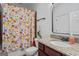 Charming bathroom features granite counters and colorful floral shower curtain at 2265 Venture Dr, Marietta, GA 30062