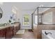 Bathroom featuring double vanity, framed mirrors, separate shower, and soaking tub at 2265 Venture Dr, Marietta, GA 30062