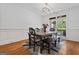 Dining room with hardwood floors, wainscotting, and a modern light fixture, next to a window at 2265 Venture Dr, Marietta, GA 30062