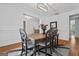 Bright dining room with hardwood floors, wainscoting, modern light fixture and a vase of red roses at 2265 Venture Dr, Marietta, GA 30062