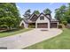 Beautiful stone-accented home featuring a manicured lawn and a spacious driveway leading to a two-car garage at 2265 Venture Dr, Marietta, GA 30062