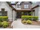 Inviting front entrance with stone accents, wooden door, and manicured landscaping at 2265 Venture Dr, Marietta, GA 30062