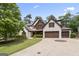 Attractive home featuring a stone facade, a three-car garage, and a well-manicured lawn at 2265 Venture Dr, Marietta, GA 30062