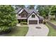 Striking home exterior featuring a stone facade, a three-car garage, and a circular driveway at 2265 Venture Dr, Marietta, GA 30062