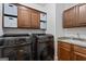 Well-organized laundry room with modern washer, dryer, sink, and ample cabinet space at 2265 Venture Dr, Marietta, GA 30062