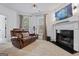 Comfortable living room featuring a fireplace, large TV, and leather reclining loveseat at 2265 Venture Dr, Marietta, GA 30062