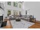 Spacious living room with high ceilings, large windows, fireplace, and comfortable gray sectional sofa at 2265 Venture Dr, Marietta, GA 30062