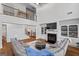 Open-concept living room with a fireplace, built-in shelves, and a gray sectional sofa, bathed in natural light at 2265 Venture Dr, Marietta, GA 30062