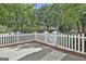Lovely backyard featuring a white picket fence, lush greenery, and shade trees at 100 Concord Ct, Fayetteville, GA 30214
