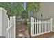 Charming backyard with a white picket fence and lush landscaping, creating a serene outdoor space at 100 Concord Ct, Fayetteville, GA 30214