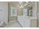 Well-lit bathroom with double vanity, generous mirror, tub, and walk-in shower at 100 Concord Ct, Fayetteville, GA 30214