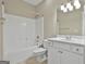 Well-lit bathroom with a tub-shower combination, white vanity, and neutral tile flooring at 100 Concord Ct, Fayetteville, GA 30214
