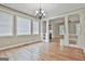 Dining room featuring hardwood floors, chandelier, and architectural columns at 100 Concord Ct, Fayetteville, GA 30214