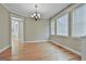 Dining room featuring hardwood floors, chandelier, and large windows with ample natural light at 100 Concord Ct, Fayetteville, GA 30214