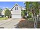Exterior of a home showcasing the garage, driveway, and manicured landscaping at 100 Concord Ct, Fayetteville, GA 30214