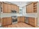 Well-lit kitchen with stainless steel appliances and custom wood cabinetry and breakfast bar at 100 Concord Ct, Fayetteville, GA 30214