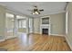 Bright living room with hardwood floors, fireplace, and large openings into other living spaces at 100 Concord Ct, Fayetteville, GA 30214