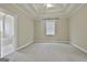 Spacious bedroom has a tray ceiling, a ceiling fan, and an adjoining bathroom with a garden tub at 100 Concord Ct, Fayetteville, GA 30214