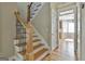 Elegant staircase with wood treads, decorative iron railings, and a view of the open-concept layout at 100 Concord Ct, Fayetteville, GA 30214