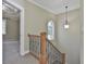 Upper staircase landing features a window and view of a bedroom with a tray ceiling at 100 Concord Ct, Fayetteville, GA 30214