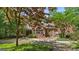 Charming brick home with landscaped backyard and mature trees, perfect for outdoor enjoyment and relaxation at 9274 Betony Wood Trl, Jonesboro, GA 30236