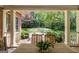 Inviting backyard view from the covered patio, featuring a lush garden and brickwork at 9274 Betony Wood Trl, Jonesboro, GA 30236